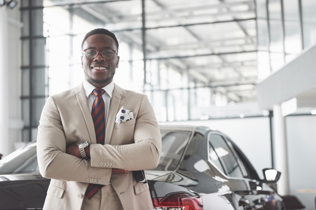 young-black-businessman-auto-salon-car-sale-rent-concept_146671-18395